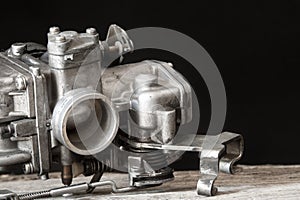 Carburetor on wooden surface photo