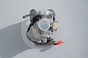 Carburettor for scooter on a gray background