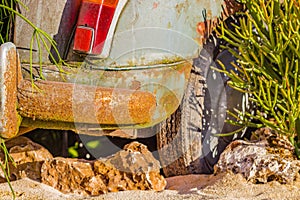 Carcass of an old rusty car in the desert