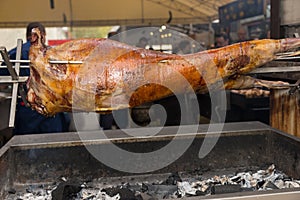 Carcass of a pig or lamb roasting over a spit