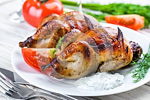 Carcasses of quail with tomatoes