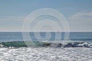 carcavelos beach with surfers and boat