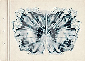 Card of color Rorschach inkblot test. A sheet of old paper stained with blue symmetric watercolor blots. Grunge artistic backgroun