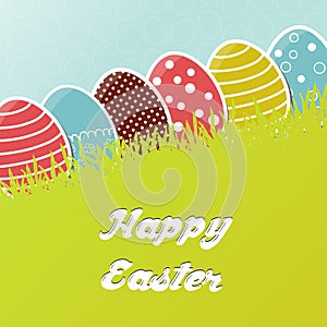 Card with colorful Easter eggs in grass