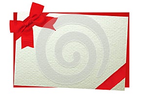 The card decorated with a red bow on envelope isolated on white