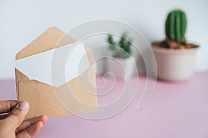 Card with envelope,has space for text. Brown envelope with a blank piece of white paper