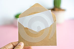 Card with envelope,has space for text. Brown envelope with a blank piece of white paper