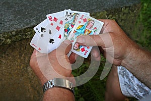 Playing cards in hands