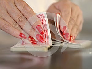 Card game shuffle with two hands in close-up