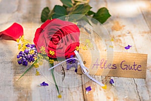 Card with german text, Alles Gute, means all the best and bunch of romantic rose flower