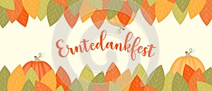 Card with german text Erntedankfest, translation of Thanksgiving with pumpkins and leaf.