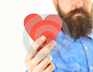 Card in heart shape in hand of bearded hipster