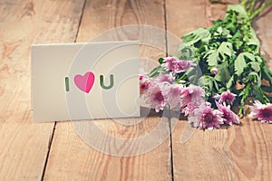 Card with Message Love You on the Letter on wooden background