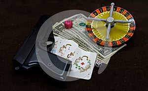 Card with money. gun and roulette