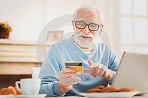 Man checking his debit card number while conducting transaction