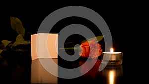 Card with Rose and Candle on Shiny Black Surface