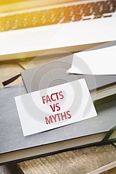 Card saying Facts vs Myths on note pad