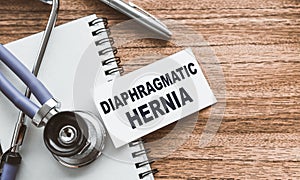 A card with text Diaphragmatic hernia on wooden doctor`s table