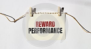 Card with text REWARD PERFORMANCE. Diagram and white background