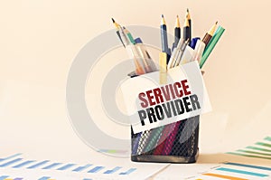 Card with text SERVICE PROVIDER on the pen box in the office. Diagram and white background