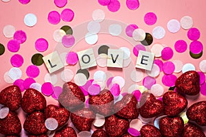 Card for valentine`s day. on a pink background wooden letters lined with love. funny congratulations. Flat lay, top view