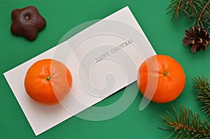 Card with a wish of happy christmas tangerines and coniferous branches