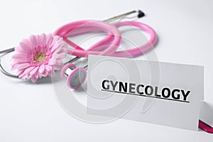 Card with word Gynecology, clipboard, stethoscope and flower