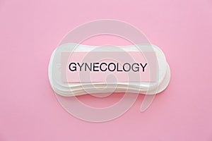 Card with word GYNECOLOGY and menstrual pads