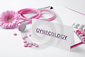 Card with word Gynecology, pills, stethoscope and flower