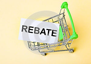 The card with the word REBATE is in the shopping cart. Marketing concept