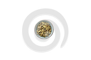 Cardamom pods in a ceramic bowl. Isolated white background