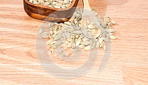 Cardamom pods on the wooden background