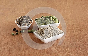 Cardamom Powder, Seeds, and Pods in Bowls