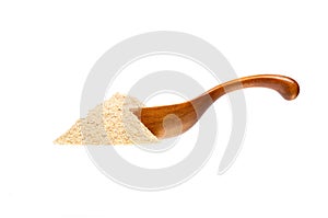 Cardamom in the wooden spoon, isolated on white background.