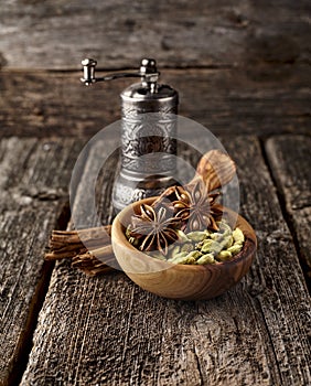 Cardamon, cinnamon and anise on wooden background