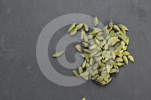 Cardamon pods on grey stone table