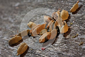 Cardamon pods on wooden background