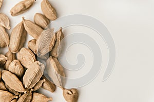 Cardamon seeds on a white background