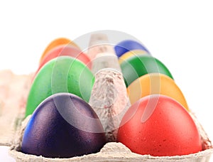 Cardboard box with Easter colored eggs.