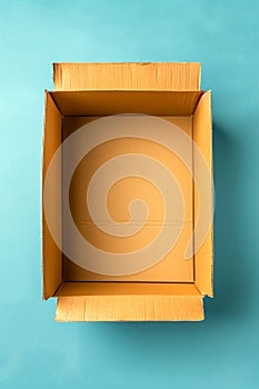 A cardboard box is empty and sits on a blue background