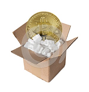Cardboard box with filling material with golden bitcoin