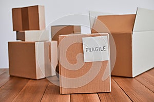 Cardboard box with fragile label on wooden desk