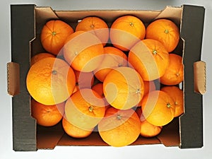 Cardboard box with fresh oranges