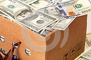 Cardboard box full of dollars