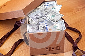 Cardboard box full of dollars banknotes. Corruption