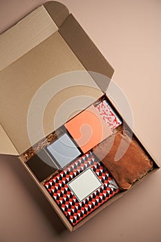 Cardboard box with gifts, top view. Open gift box