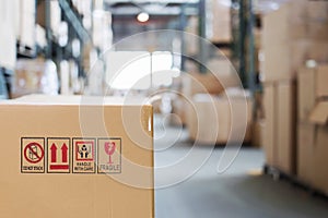 Cardboard box with goods on the background of a blurry modern warehouse