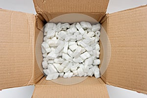 A cardboard box with packing foam pellets