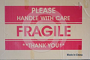 Cardboard Box side with words of warning, Please Handle with Care, Fragile, and Thank You, printed in the center with Made in Chin