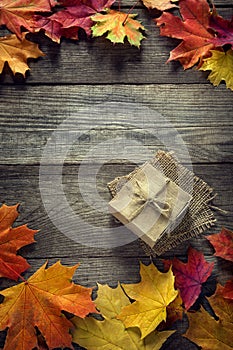 Cardboard box tied with string on a bow on a wooden background i